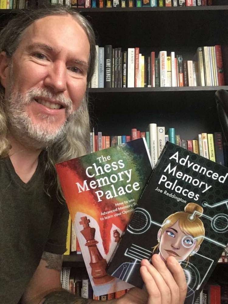 Anthony Metivier holding copies of The Chess Memory Palace and Advanced Memory Palaces