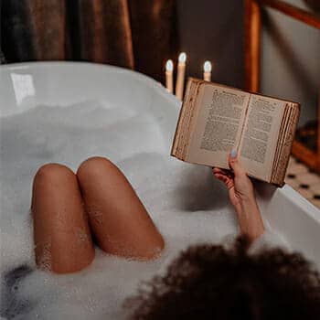 benefits of reading woman relaxed with book in a hot tub