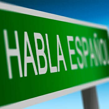 Spanish phrases feature image of a sign asking if you speak Spanish