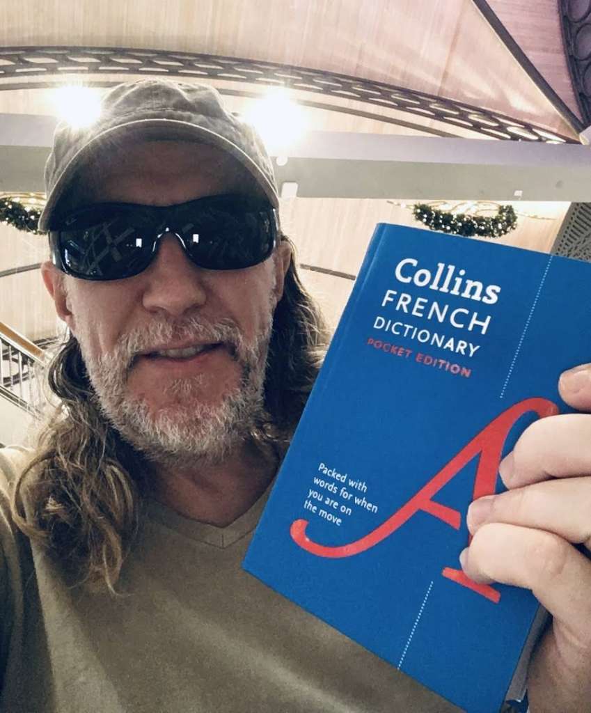 Anthony Metivier holding a French dictionary