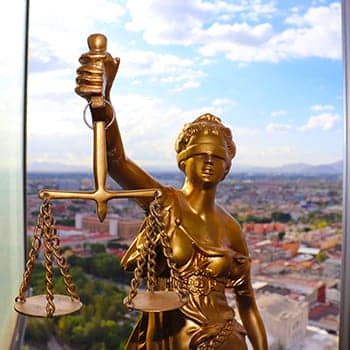 how to succeed in law school image of lady justice statue in a window