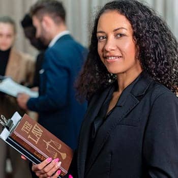 how to remember sections in law feature image of a woman holding a legal textbook