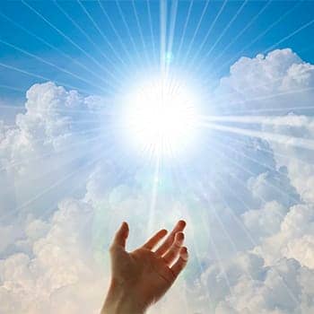 why memorize scripture feature image of a hand reaching out to light in the sky
