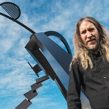 Anthony Metivier with a sculpture to express a concept related to intellectual activities