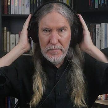 Do subliminals work feature image of Anthony Metivier pressing his hands against headphones