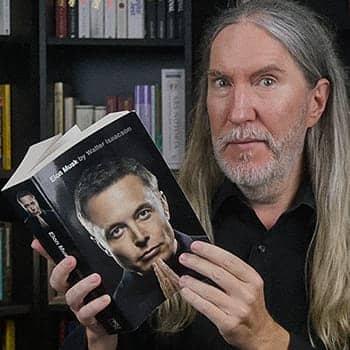 Is Elon Musk a polymath feature image of Anthony Metivier holding the biography by Walter Isaacson