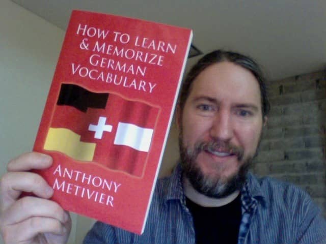Anthony Metivier holding a copy of How to Learn and Memorize German Vocabulary