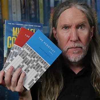 Anthony Metivier holding books related to artificial intelligence.